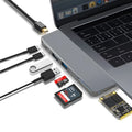 Silver 8-in-1 USB-C hub for MacBook Pro with dual connectors, showing USB, card reader, and charging ports