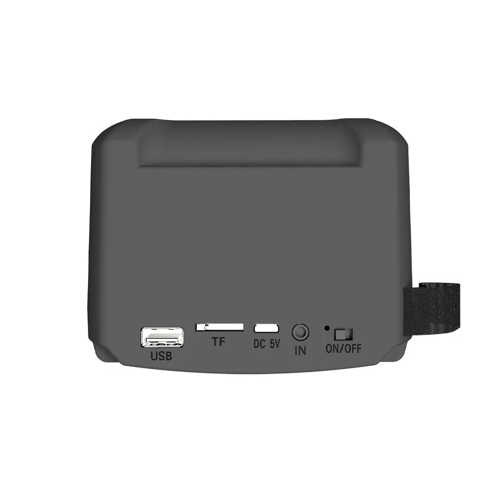 Compact portable Bluetooth speaker in neutral colour with USB charging cable.