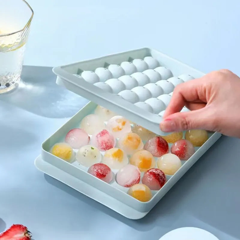Round blue silicone ice cube tray with lid showing 33 compartments