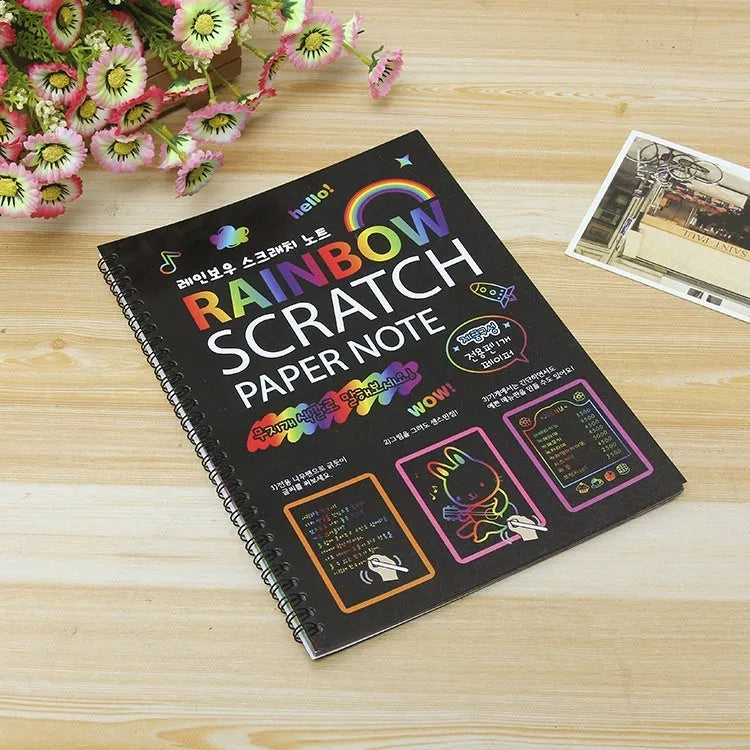 Large rectangular scratch art paper for children with a scraping tool on a colourful puzzle design background.