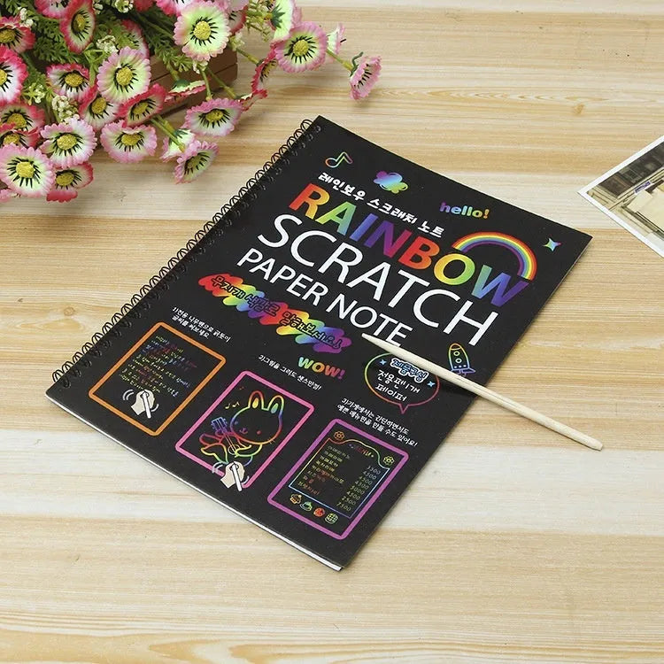 Large rectangular scratch art paper for children with a scraping tool on a colourful puzzle design background.
