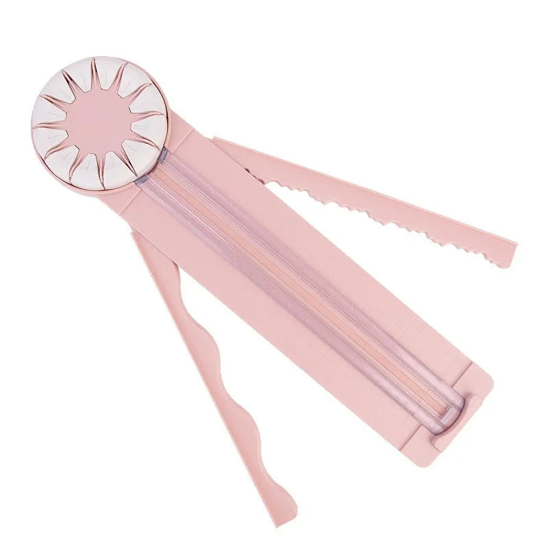 Pink plastic paper cutting machine with dotted pattern design and 12 interchangeable blades