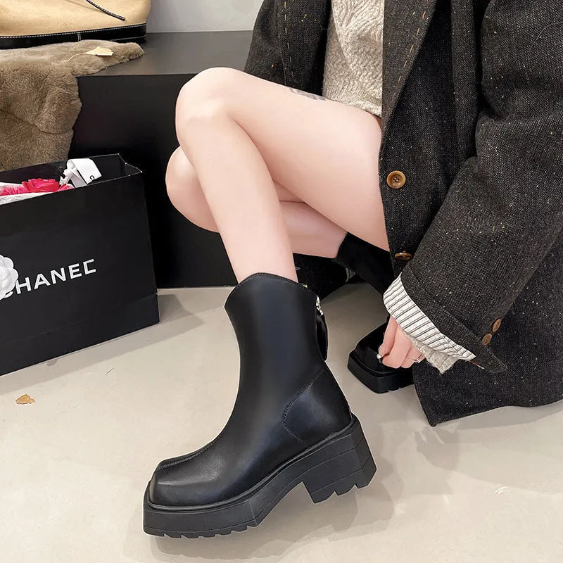 Women's black platform Martin ankle boots with a square toe and back zipper on a white background