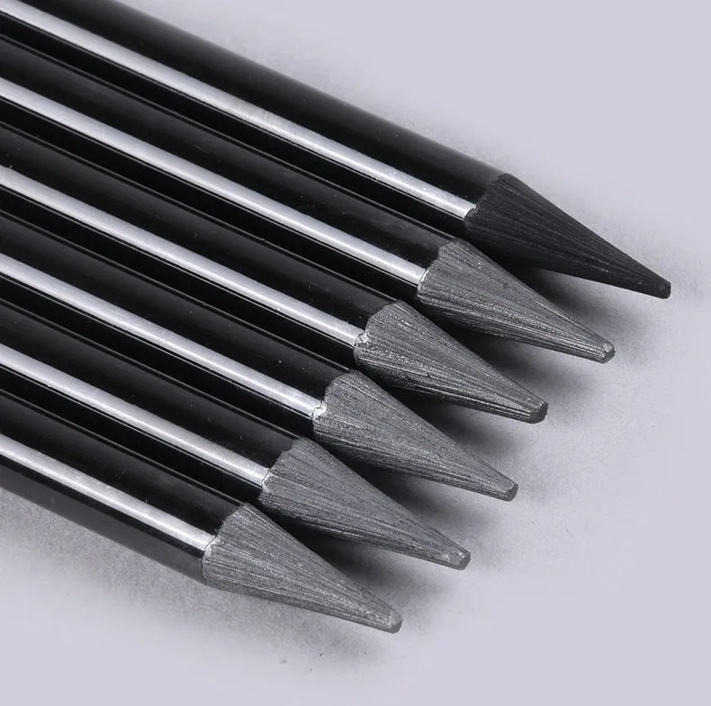 Set of nine wooden artist pencils including graphite and carbonized types on suction card packaging