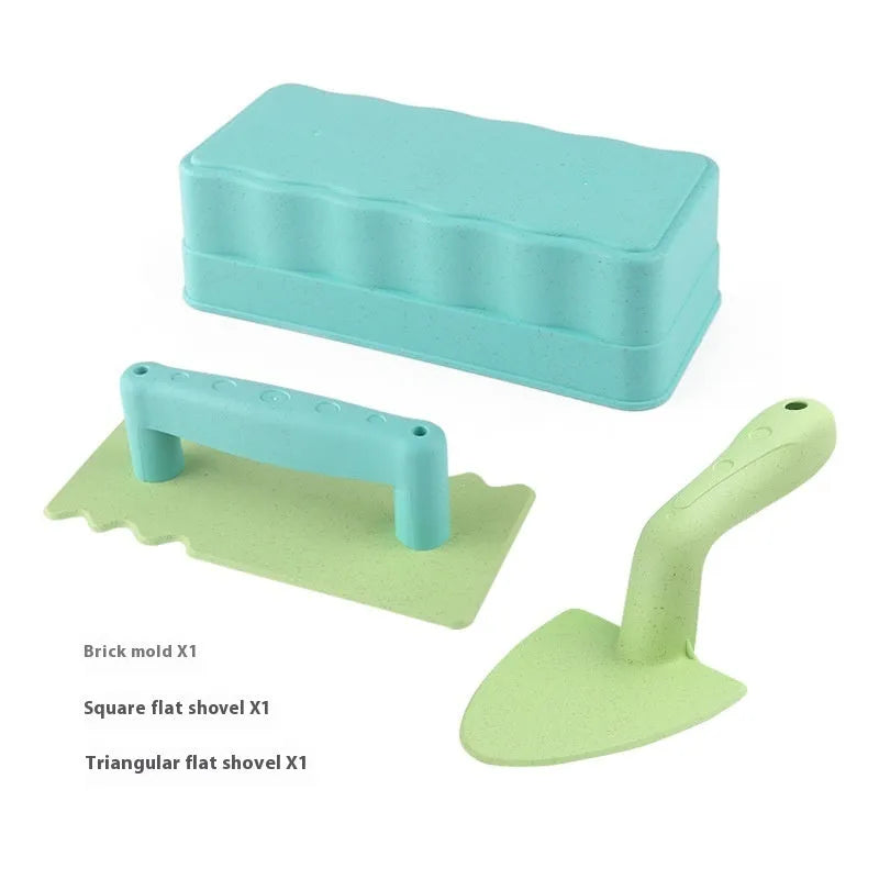 Wheat straw sand shovel brick toy in brown, 19 cm long, on sand with blurred background