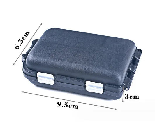 Black plastic fishing tackle storage box with 10 internal compartments, shown next to a ruler.
