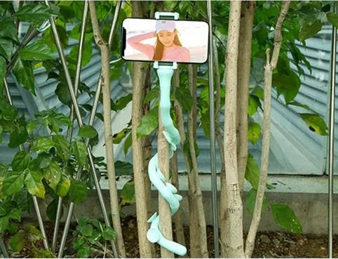 Flexible rubber phone holder with suction cup mount showing 360 degree rotation capability