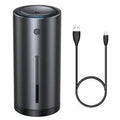 Black aluminium alloy car diffuser humidifier with USB cable on a desk.