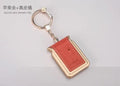 Bluetooth dual SIM adapter keychain for iOS with Nano SIM slot and Micro USB port.