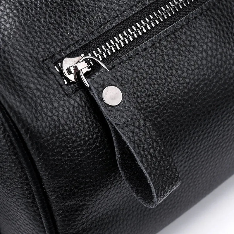 Black genuine leather crossbody bag with polyester lining measuring 24x16x13cm
