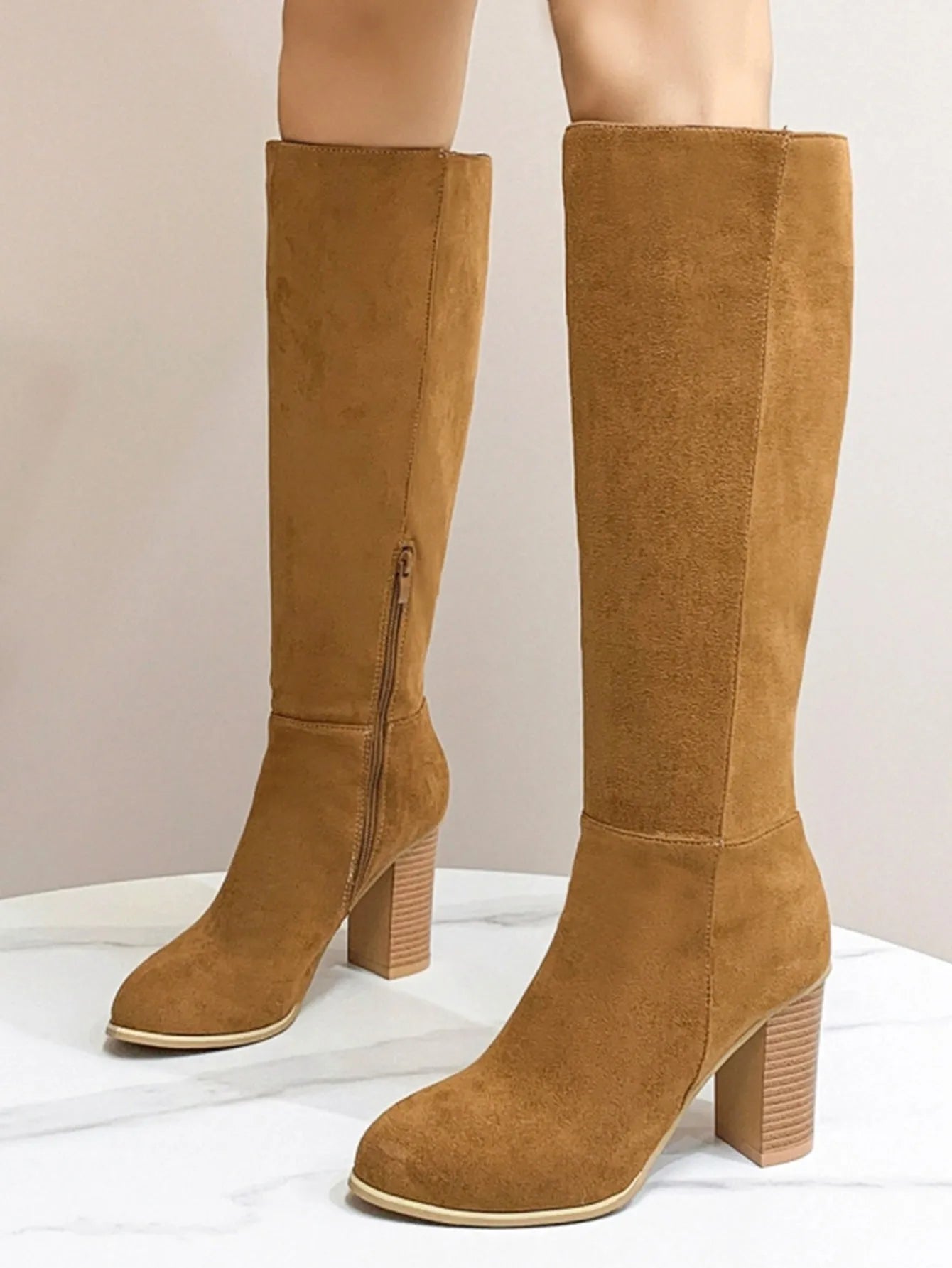 Women's black square toe high heel fashion boots made from artificial PU, shown from the side.