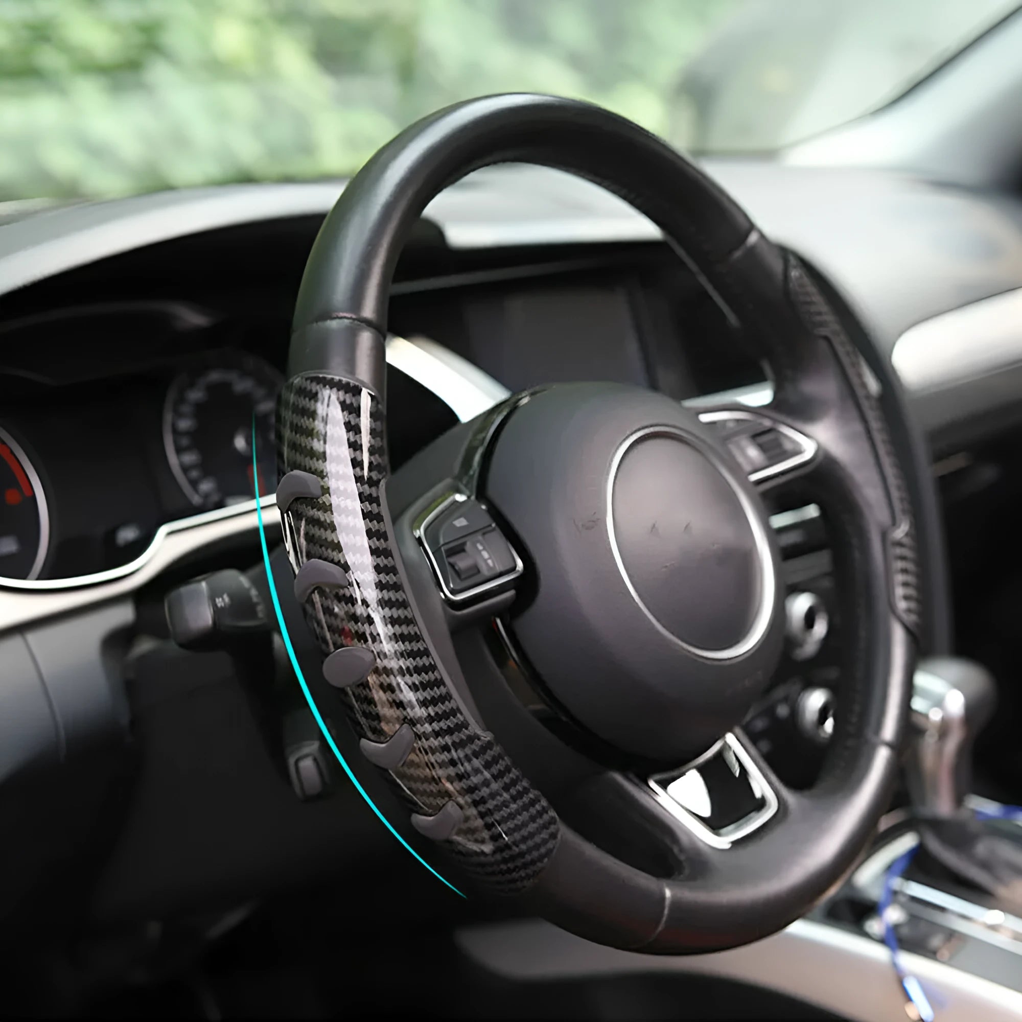 Carbon fibre black fibre anti-skid sleeve on a car steering wheel.