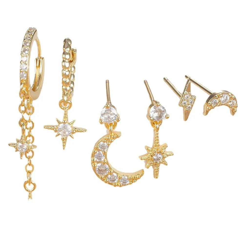 XINGX gold chain tassel earrings set with zircon stud accents, six individual pieces shown