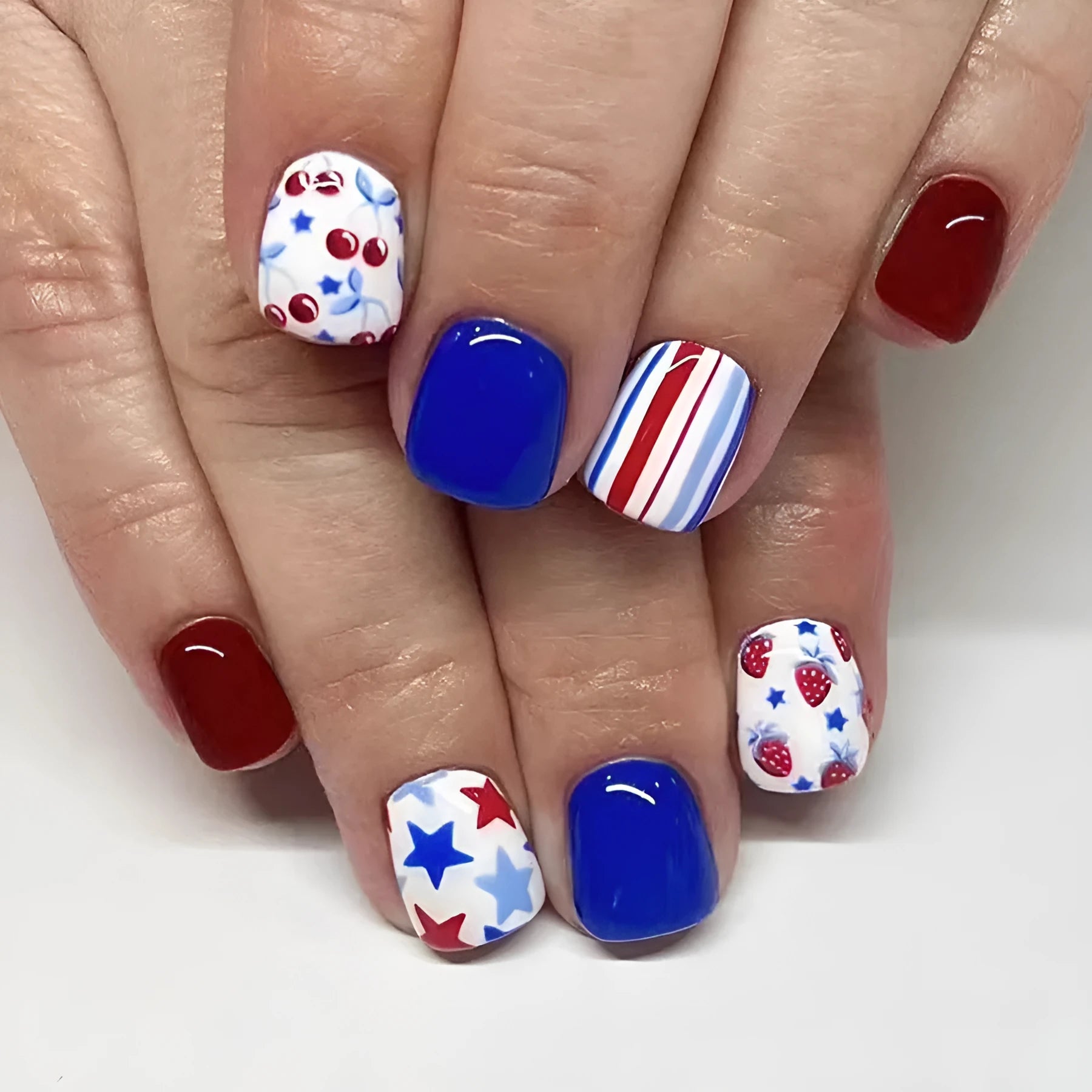 24 short glossy nail stickers with red and blue strawberry and cherry pattern