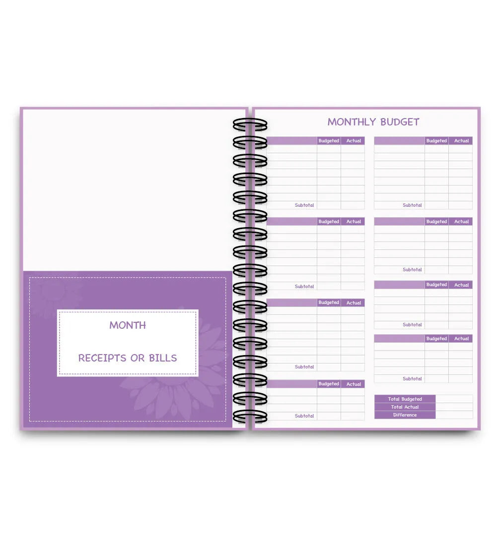 J12 Purple coil-bound monthly financial planning notebook with pen, stickers, and paper clips on a desk.
