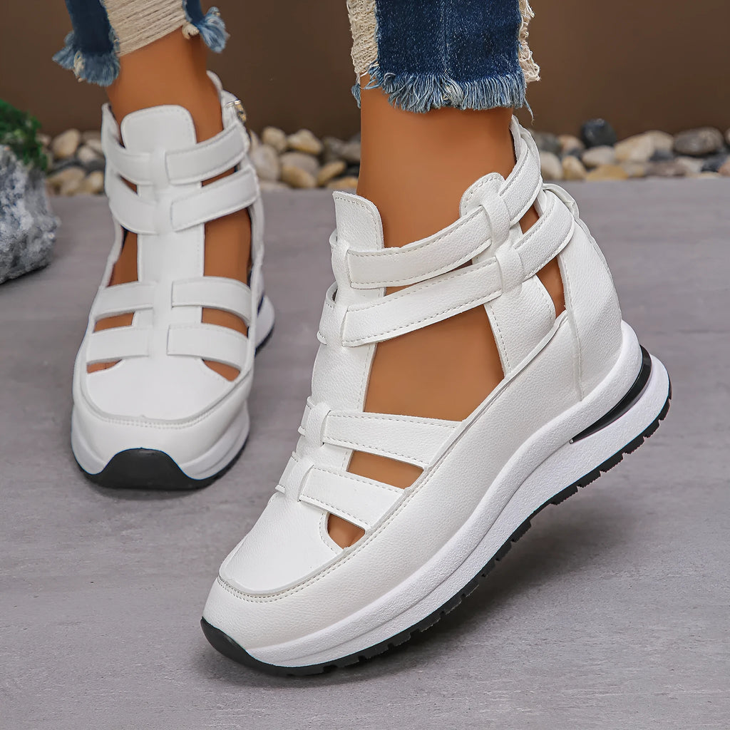 Women's black hollow-out platform sandals with Velcro fastening on a white background