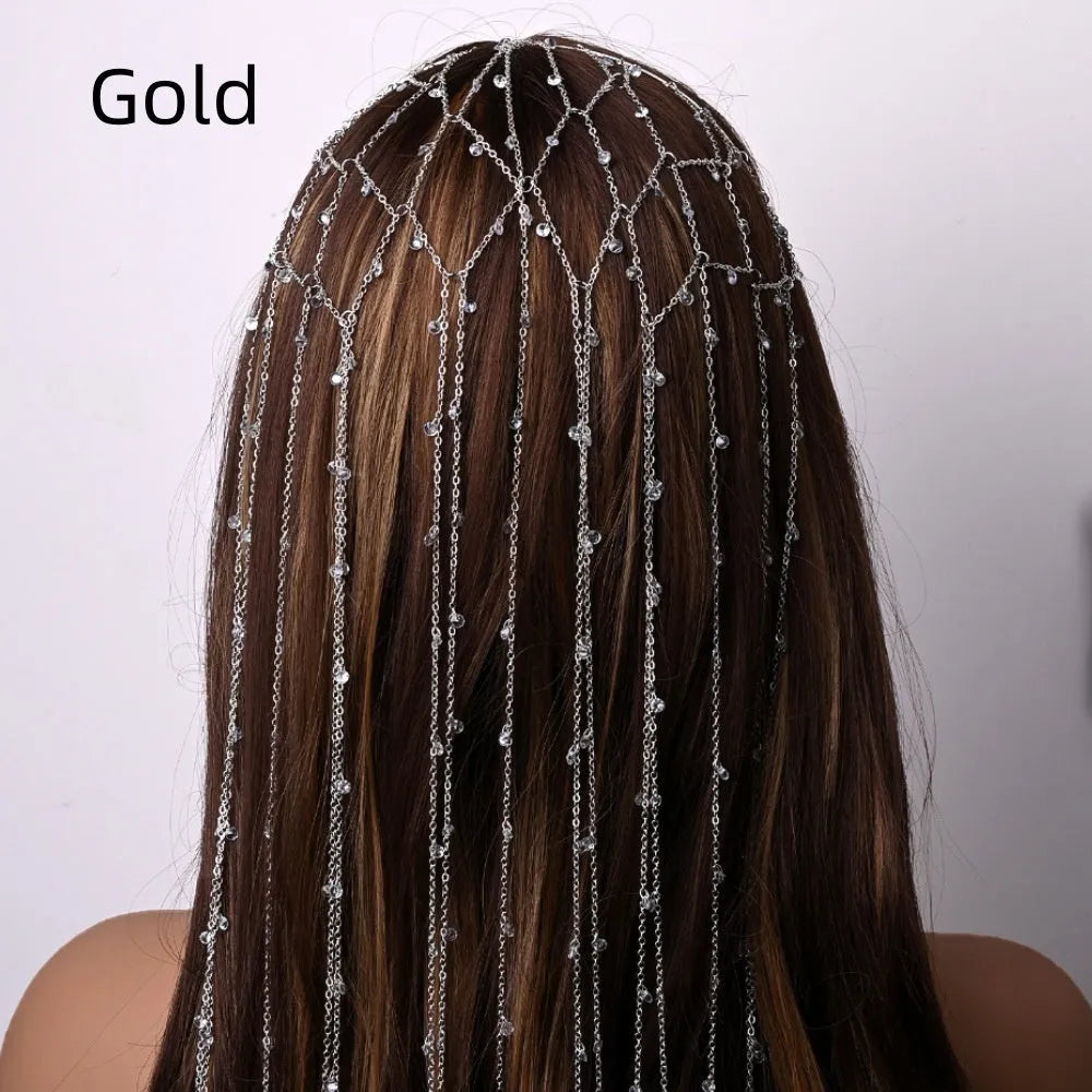 Gold coloured rhinestone hair band with a draped mesh tassel decoration.