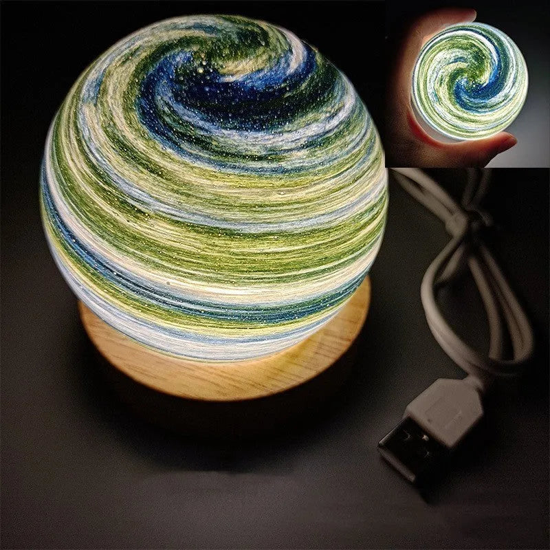 Modern planet-shaped USB night light on its base with dimmable multi-colour glow