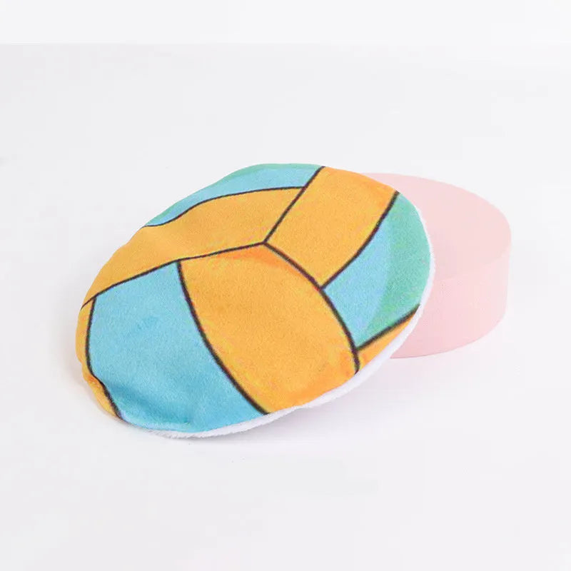 Flying disc shaped plush cat toy with sports ball pattern, containing catnip and crinkle sound.