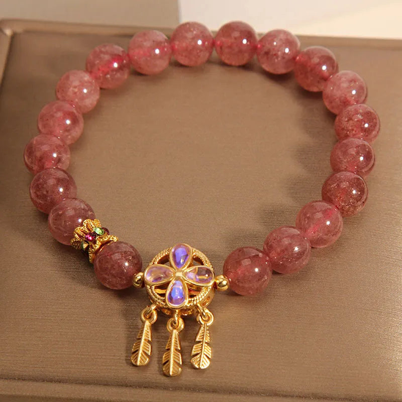 Women's strawberry quartz bracelet with four-leaf dream catcher pendant on crystal beads