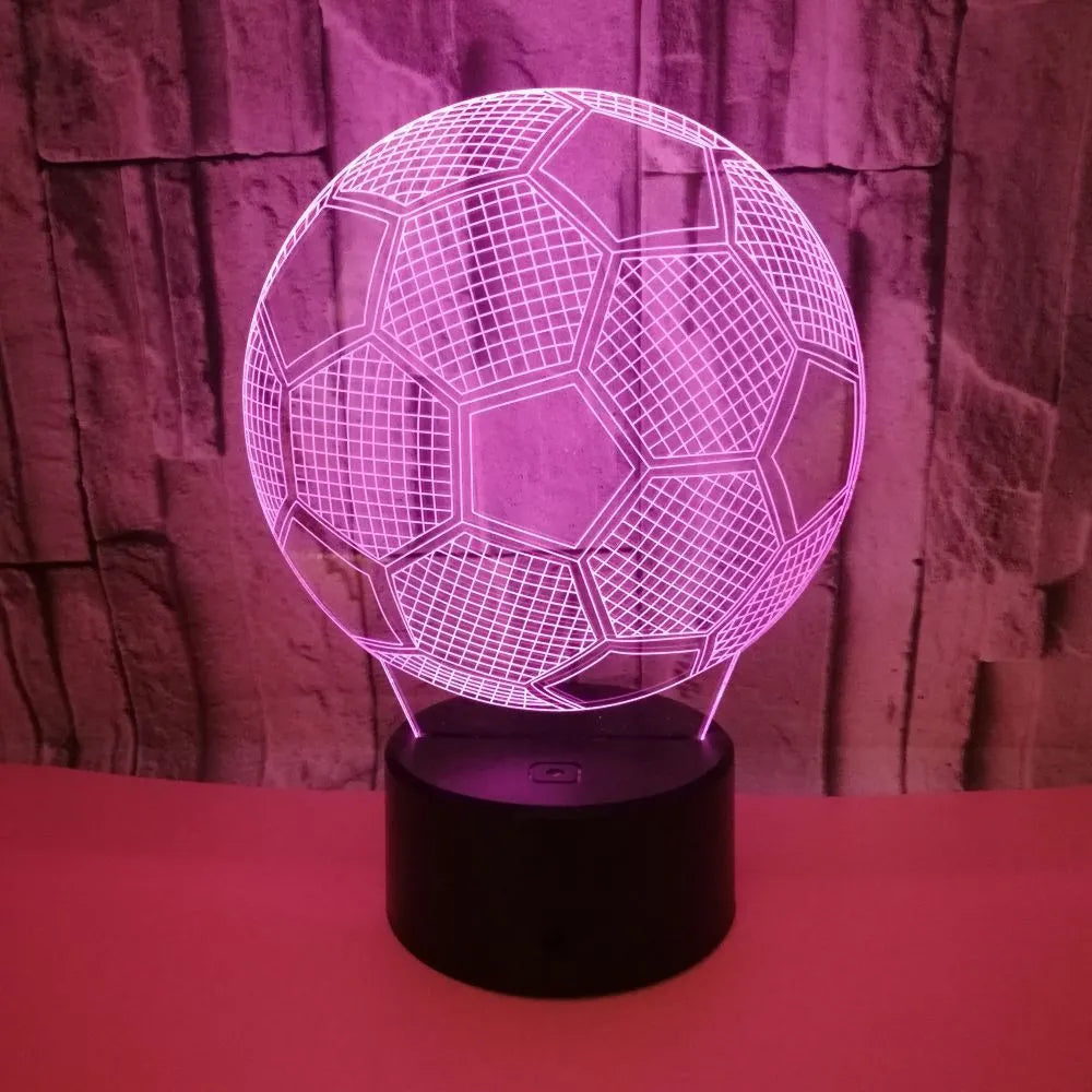 3D football-shaped night light showing multicolour illumination on acrylic surface