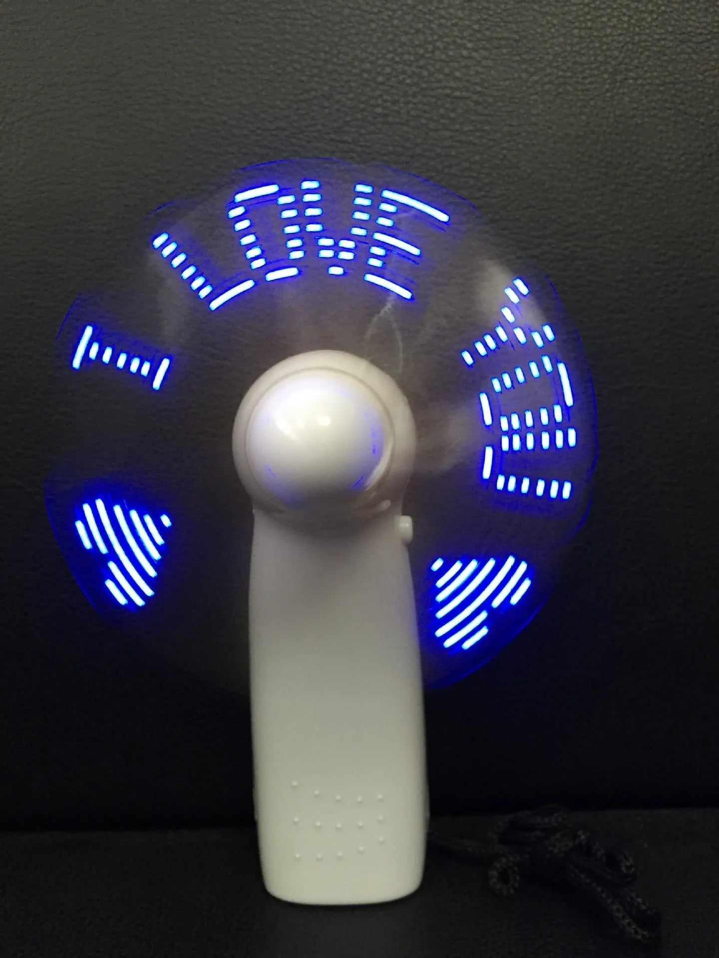 White handheld mini fan with LED love pattern display showing blue and red colours