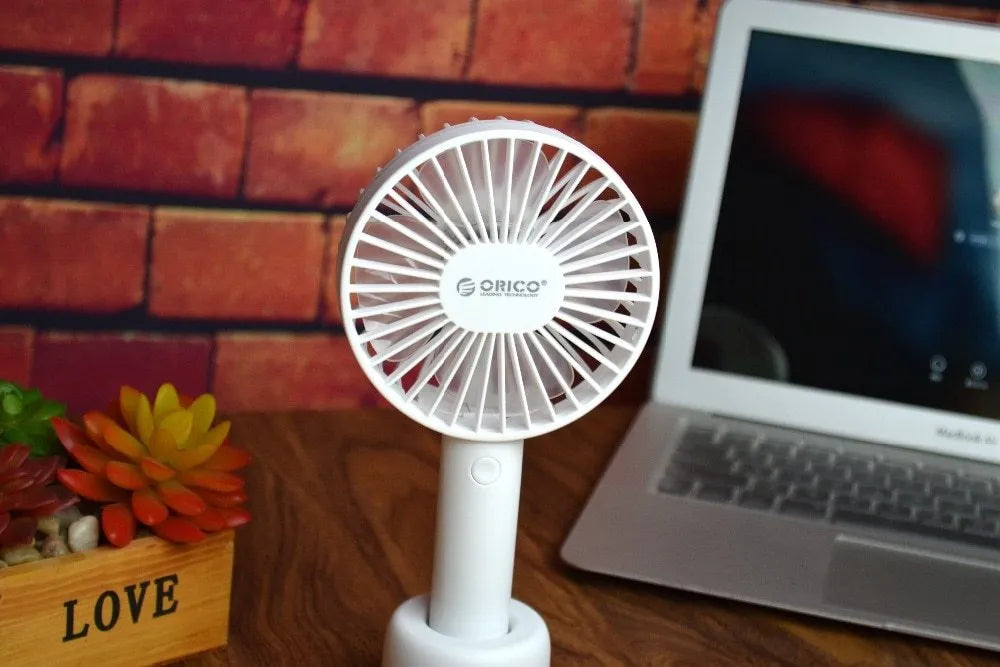 White ORICO FH1 portable USB rechargeable desk fan with fine-line texture on a desktop