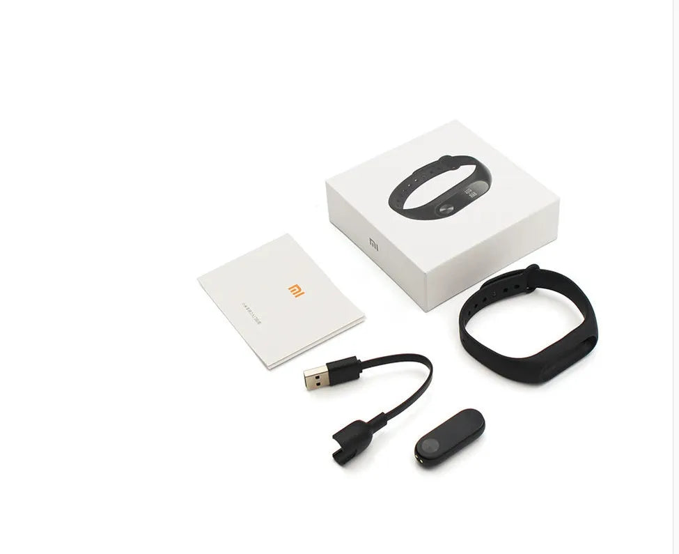 Xiaomi Mi Band 2 black fitness band with OLED screen showing heart rate data on a wrist.