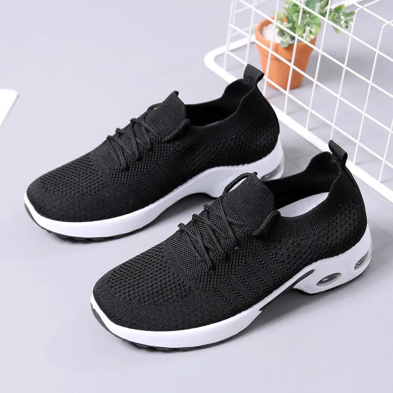 Women's casual mesh sneaker in black with lace-up front and round toe on a soft PVC sole.