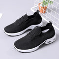 Women's casual mesh sneaker in black with lace-up front and round toe on a soft PVC sole.