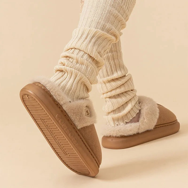 Plush fleece indoor slippers with thick PVC non-slip soles in multiple colours.