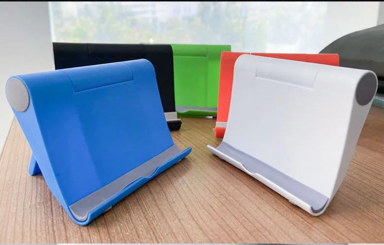 Black PE folding phone and tablet stand with soft rubber backing, shown at an adjustable angle.