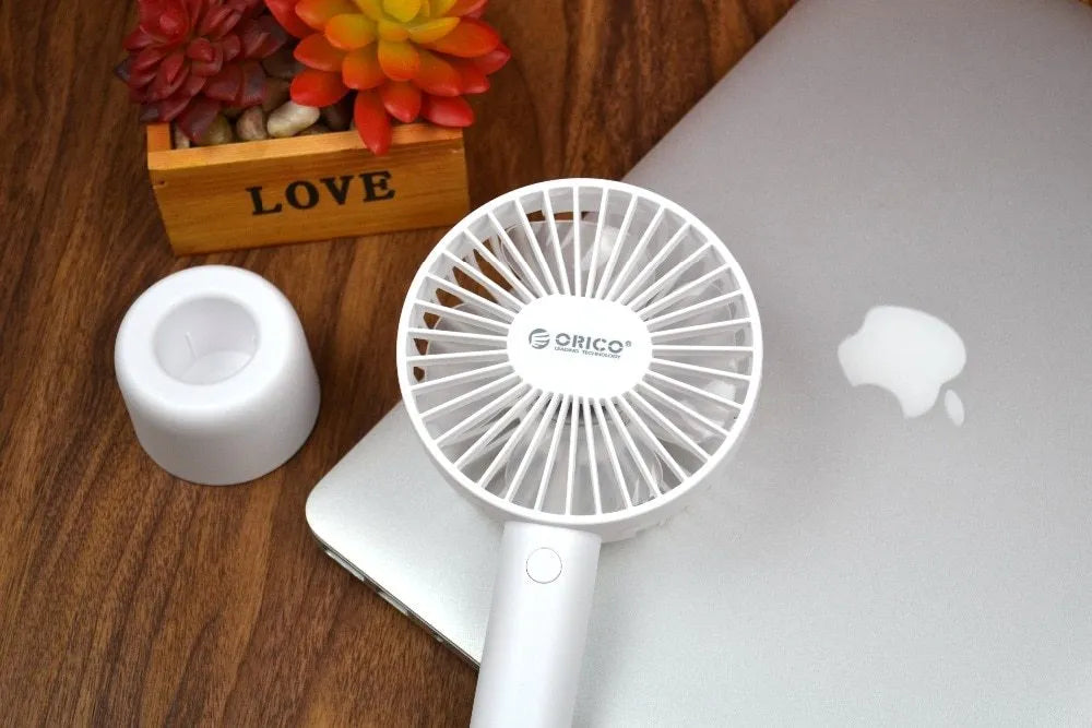 White ORICO FH1 portable USB rechargeable desk fan with fine-line texture on a desktop