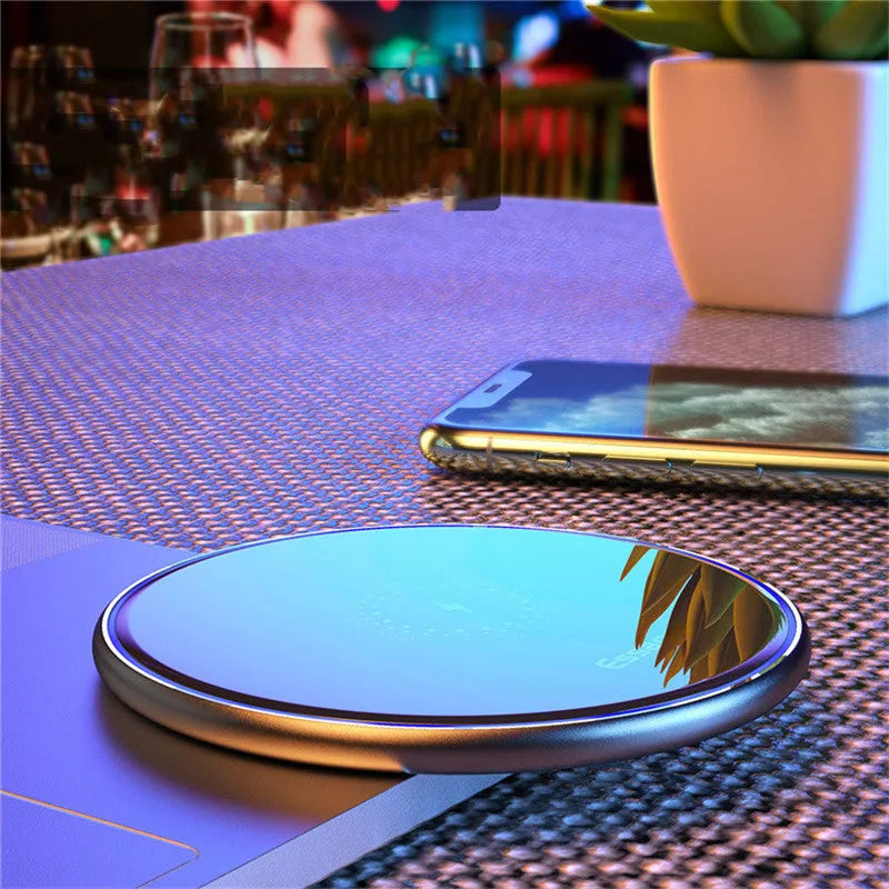 Black and white aluminium alloy wireless charging pad for phones with Qi fast charging and LED light.