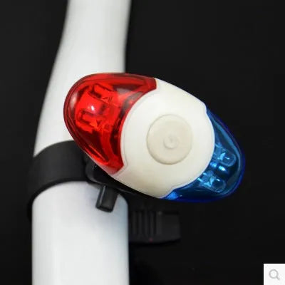 Red and blue LED tail light with adjustable mounting base on a dark background.