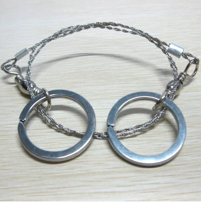 Stainless steel survival wire saw with thumb rings, extended to show its 70cm length.