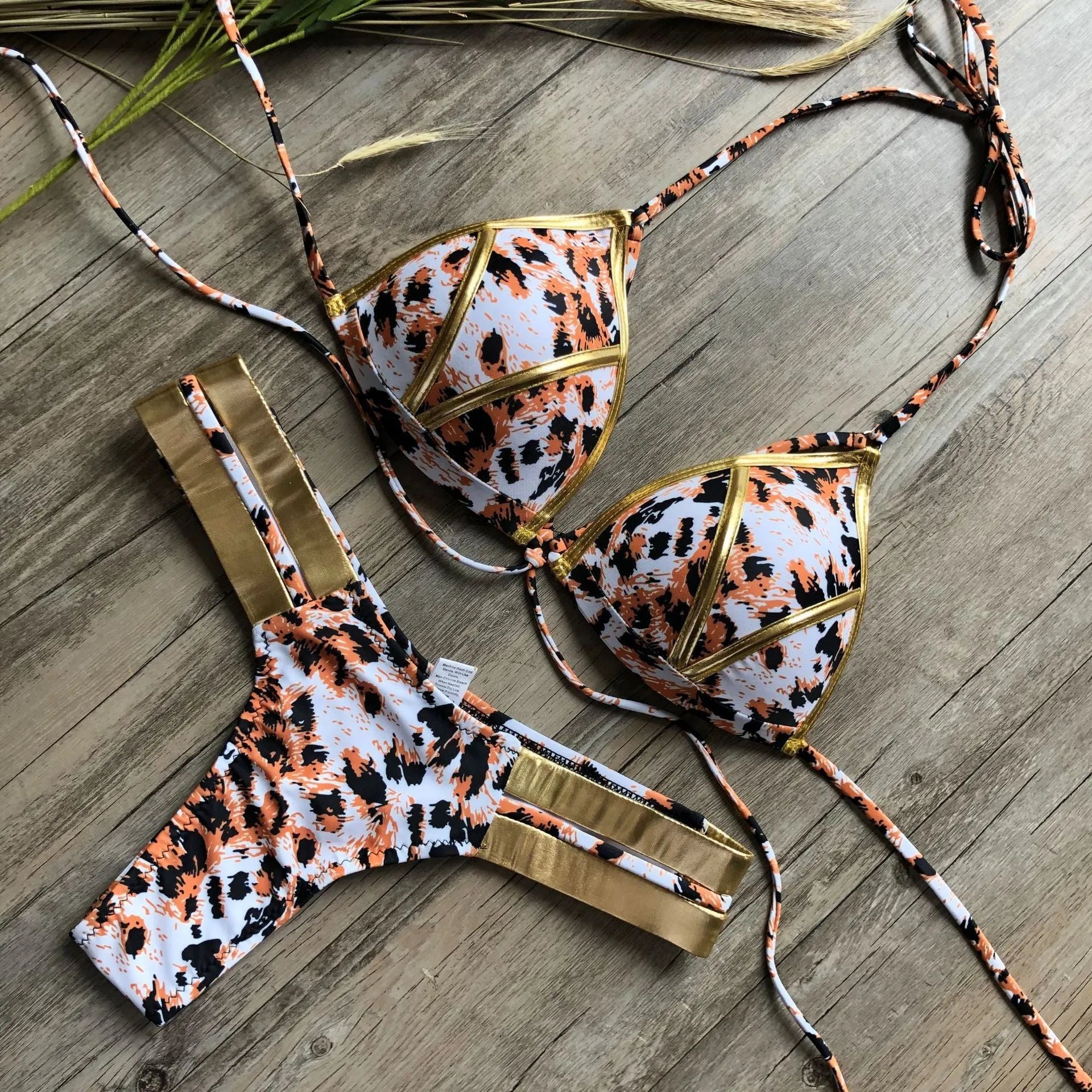 Female bronzing bikini swimwear with soft padding, shown in multiple colour and print options.
