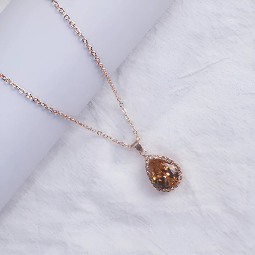 Pink rose gold drop shape rhinestone necklace with geometric design on alloy chain