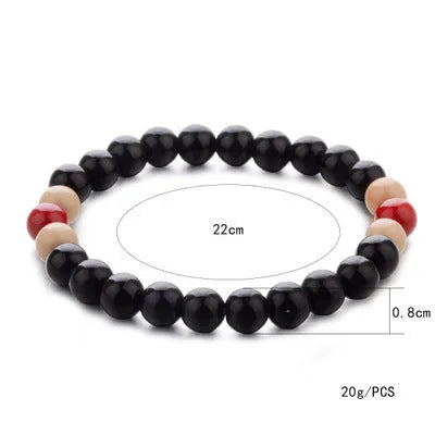 Natural lava stone beaded bracelet for men and women on a neutral background.