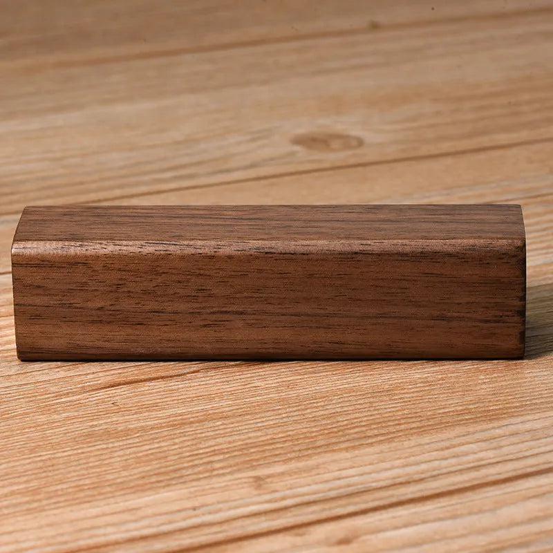 Brown black walnut solid wood portable power bank with 2000mAh capacity.