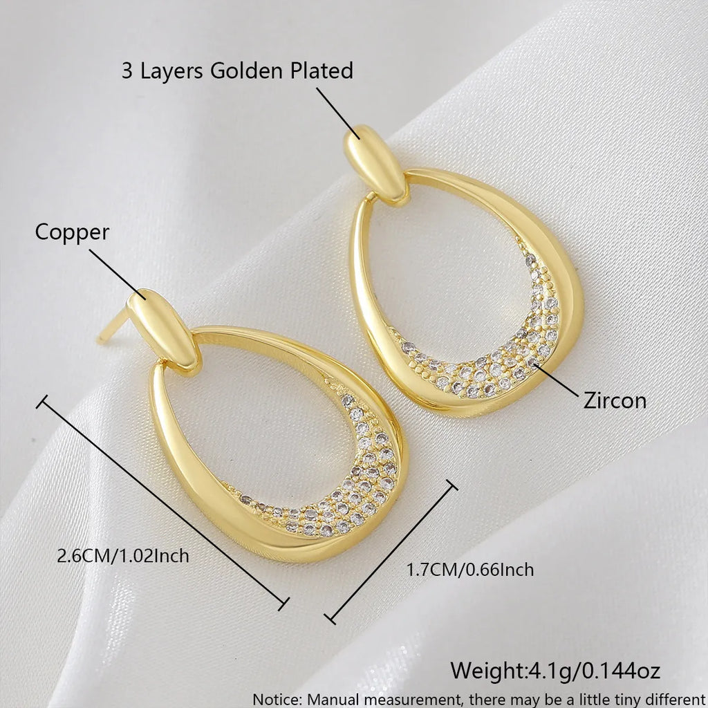 Yellow gold geometric drop earrings with ring design measuring 2.6 by 1.7 centimetres