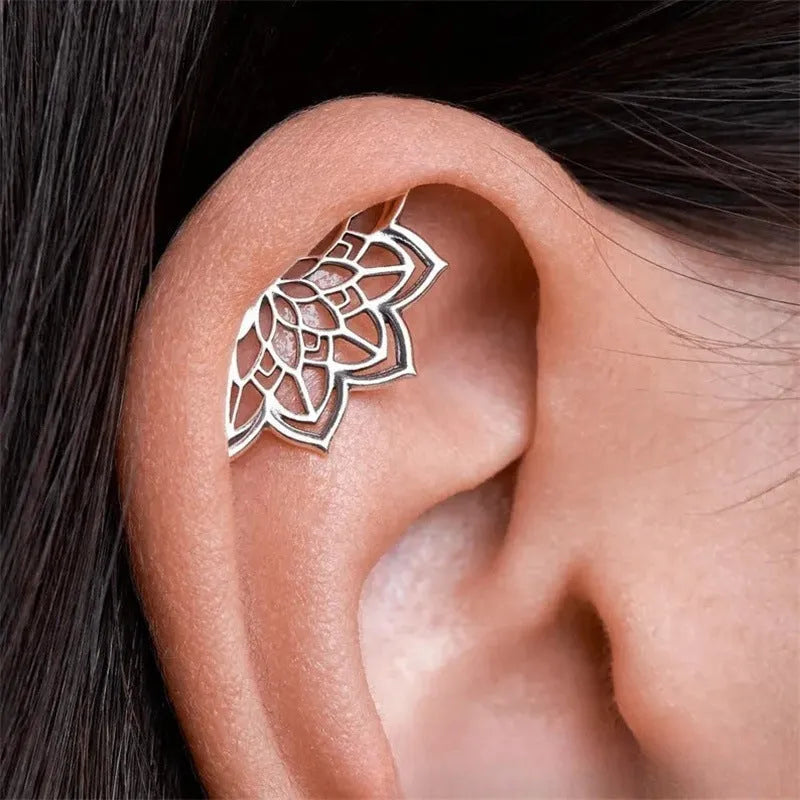 Metal spider web stud earrings in electroplated gold or silver finish, geometric mesh design.