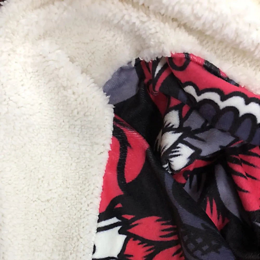 Coral coloured round flannel burrito blanket on a grey background