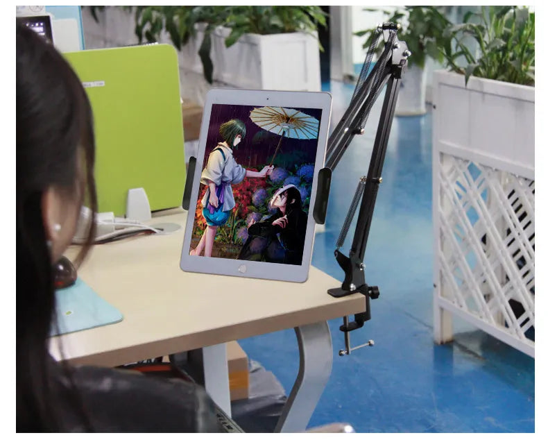 Adjustable black phone tablet stand on desktop holding mobile device at viewing angle