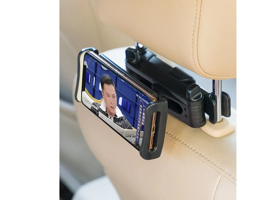 Black plastic car phone holder attached to a vehicle rear seat base holding a tablet