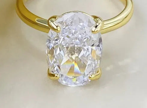 Oval gemstone ring with a four-claw setting in a choice of gold or silver colour finish.