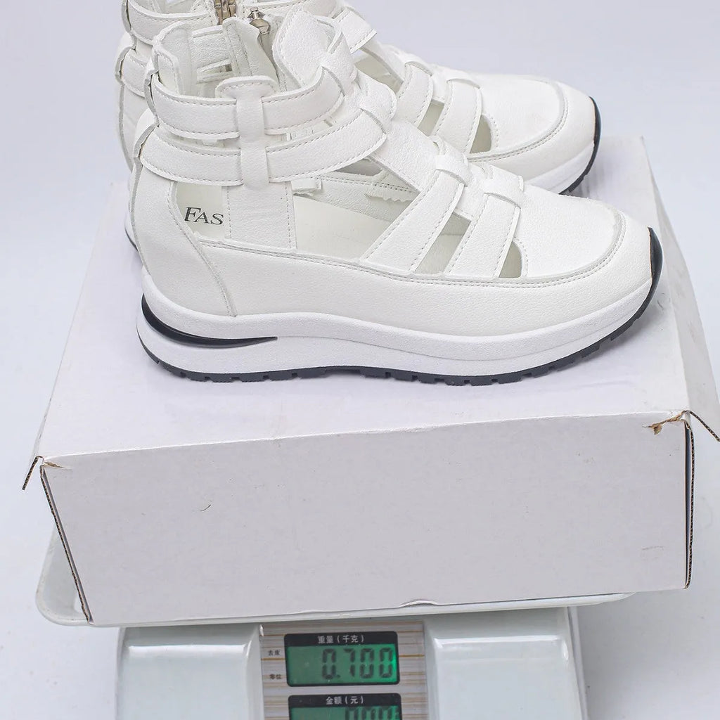Women's black hollow-out platform sandals with Velcro fastening on a white background