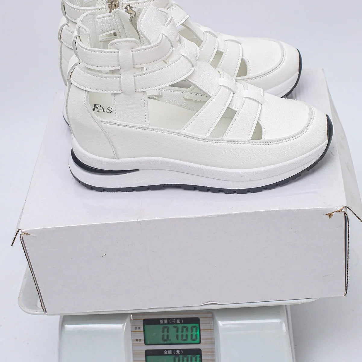 Women's black hollow-out platform sandals with Velcro fastening on a white background