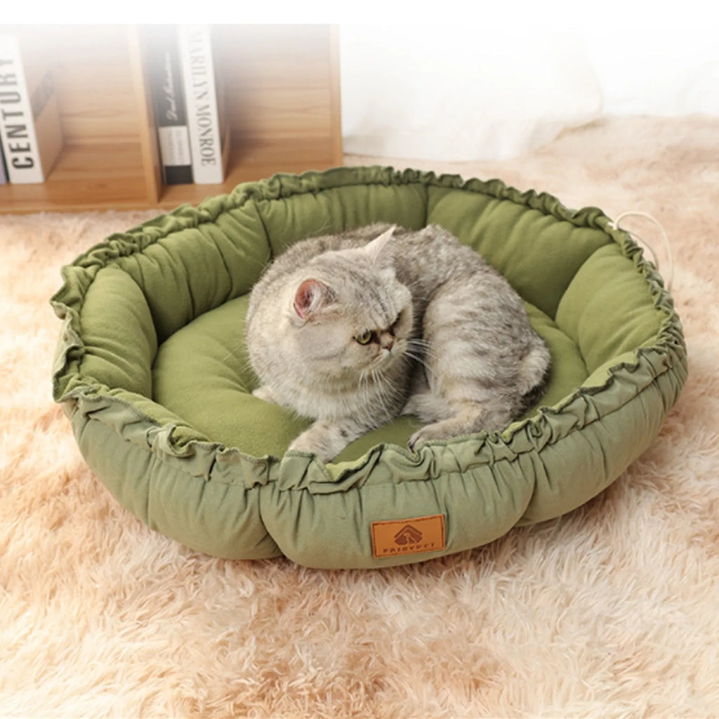 Grey donut-shaped cat bed with reversible cushion insert shown in medium size