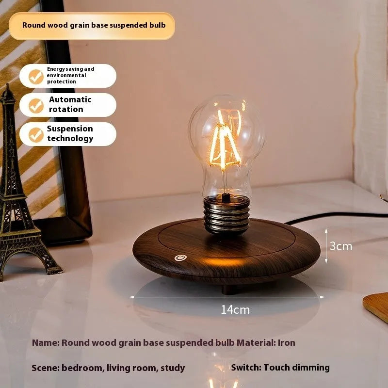 Iron art suspension bulb night lamp on a black wood grain base for desktop decoration.